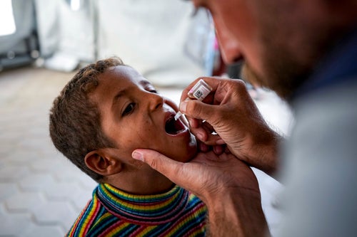 A health worker administers a polio vaccine to a child at a hospital in Deir al-Balah, central Gaza Strip, on Sept. 1, 2024. 
