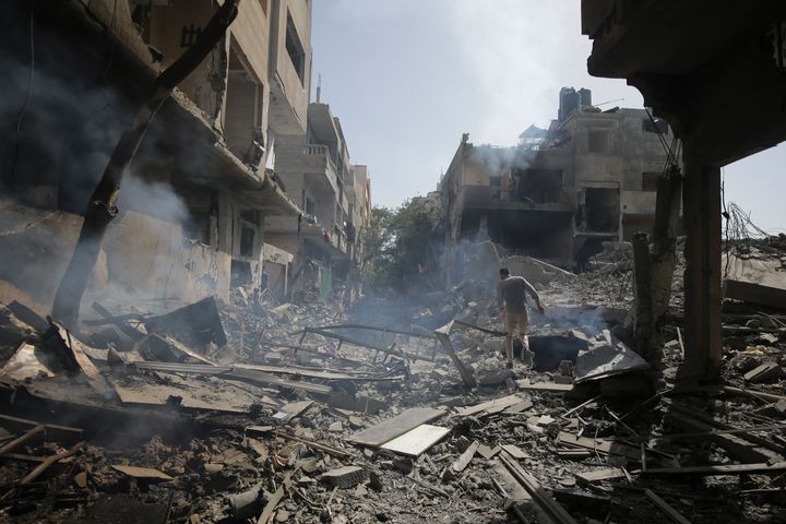 Palestinians look at the aftermath of the Israeli bombing in Nuseirat refugee camp, Gaza Strip, Saturday, June 8, 2024. 