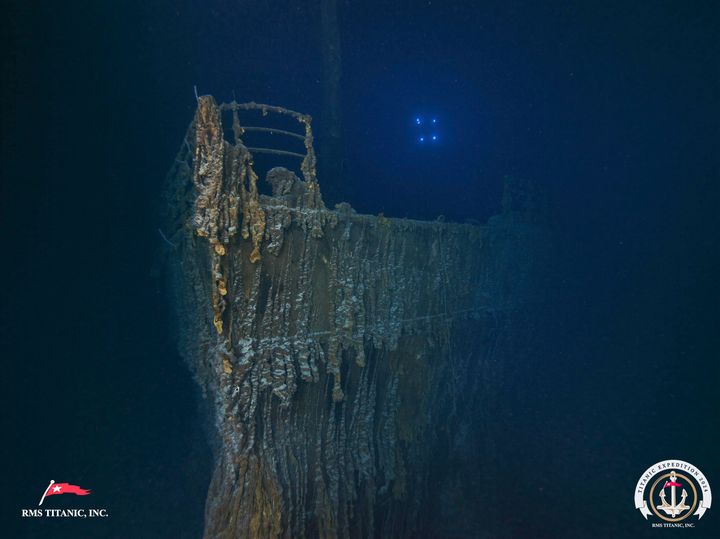 The bow of the Titanic is seen with a large section of the deck railing now missing.