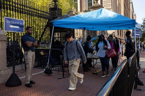 Students of Columbia University walk through a security check outside the campus, Tuesday, Sep. 3, 2024, in New York.