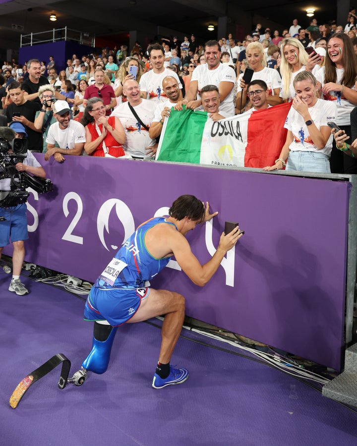 Ossola gets down on one knee in front of fans at the Stade de France.