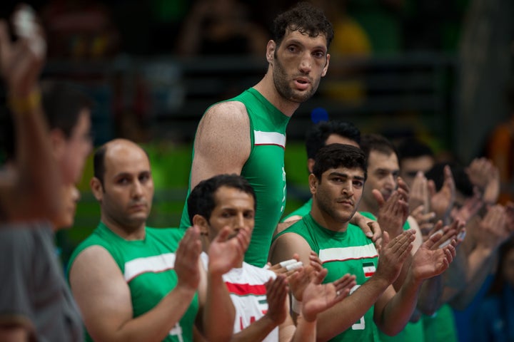 Mehrzad stands with his team during the playing of his nation's anthem before a sitting volleyball semifinal game with Brazil during the Paralympic Games in Rio de Janeiro in 2016.