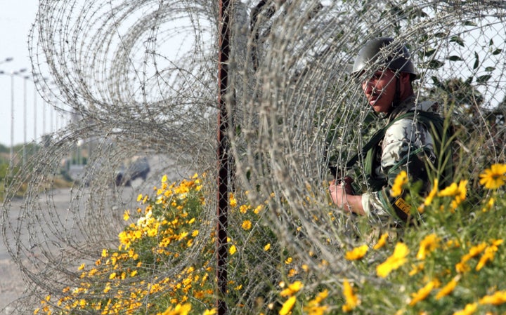 Dr. Adel Eldin An Egyptian soldier stands among the bushes in the wired border of the Philadelphi corridor, a buffer zone that separates Egypt from Israel and the Gaza Strip, March 19, 2007.