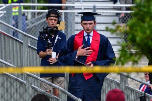 Barron Trump, son of former US President Donald Trump and former First Lady Melania Trump, takes part in his graduation at Oxbridge Academy in Palm Beach, Florida, May 17, 2024.