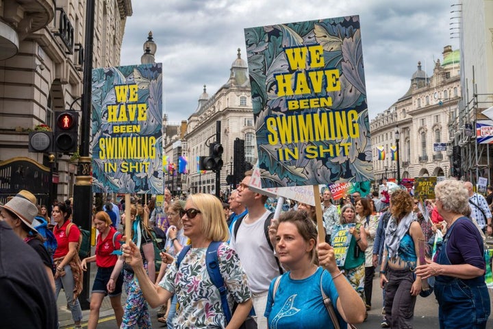 Activists protest in London against dumping raw sewage in rivers, lake and the sea.