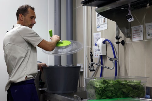 Pierre Bigot, a local sous chef, dries spinach in the kitchen of the United States Olympic and Paralympic Committee's High Performance Center kitchen on Saturday, Aug. 31, 2024. The USOPC brought in staff from Colorado and also hired local chefs to work in the kitchen.