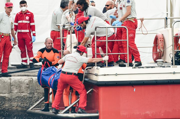 Italian firefighter divers bring ashore the body of one of the victims of a shipwreck in Porticello, Sicily, on Aug. 22.