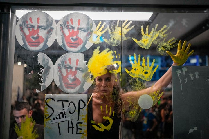 Demonstrators marks their hands on a window of a bus stop with photos of Israeli Prime Minister Benjamin Netanyahu, during a protest demanding a cease-fire deal and the immediate release of hostages held by Hamas in the Gaza Strip on Sept. 5, 2024, in Tel Aviv, Israel.