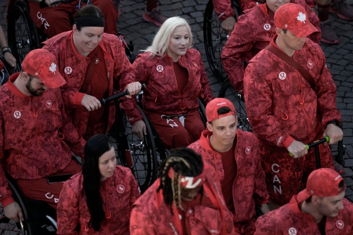 Canada's Jessica Long, centre, parades with her delegation during the opening ceremony.