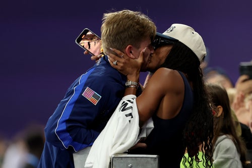 PARIS, FRANCE - SEPTEMBER 06: Gold medalist Hunter Woodhall of Team United States celebrates with wife and fellow Olympian Tara Davis-Woodhall during the Men's 400m T62 Medal Ceremony on day nine of the Paris 2024 Summer Paralympic Games at Stade de France on September 06, 2024 in Paris, France. (Photo by Ezra Shaw/Getty Images)