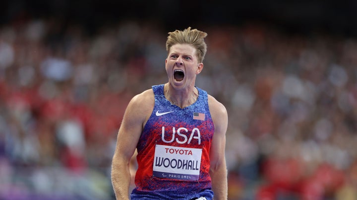 Hunter Woodhall from the U.S. celebrates after winning the men's 400 m. T62 final at the 2024 Paralympics, Friday, Sept. 6, 2024, in Paris, France. (AP Photo/Kileigh Kane)