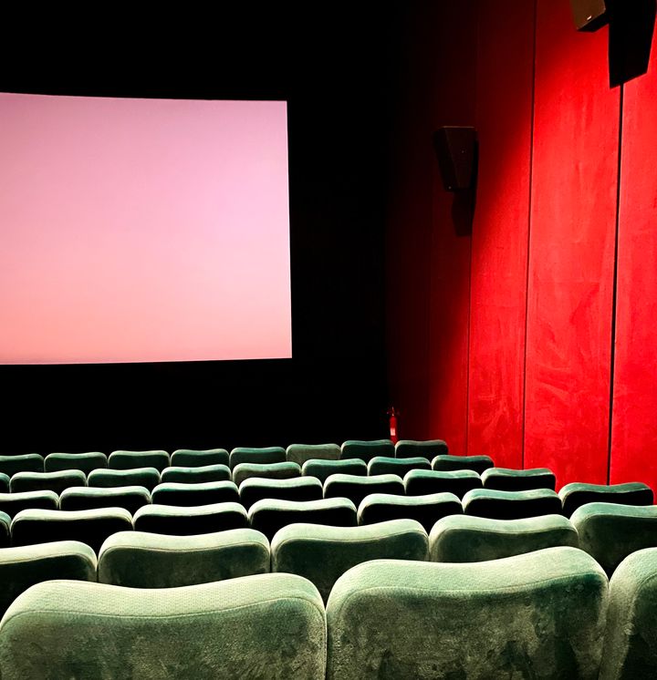 Empty Seats At Movie Theater with white screen