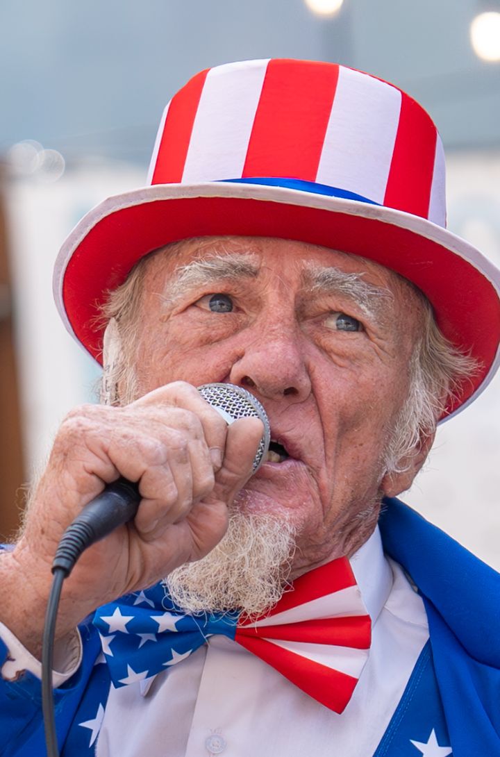 A man in an Uncle Sam costume speaks in support of Trump outside the Republican National Convention on July 19 in Milwaukee, Wisconsin.