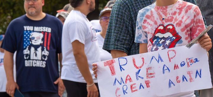 A girl holds a homemade "Make America Great Again" sign as she waits in line ahead of a rally for Trump in Johnstown.