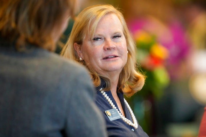 Colorado state Rep. Meg Froelich confers with another lawmaker as the legislative session opens on Jan. 9, 2023, in Denver. She has been an advocate for changes in the family court system.