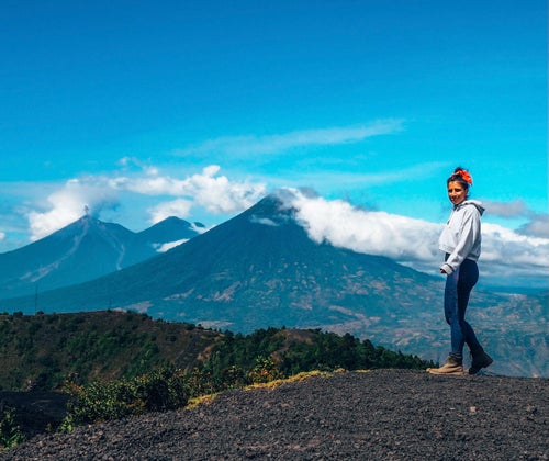Travel writer Lucy Ruthnum on top of the Pacaya volcano in Guatemala while solo traveling.