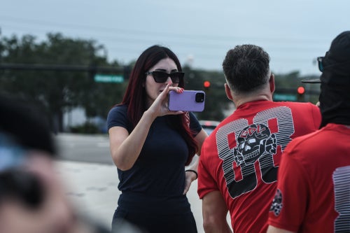 Laura Loomer, a right-wing activist, films a rally of the neo-Nazi groups Blood Tribe and Goyim Defense League on Sept. 22, 2023, in Orlando, Florida. Loomer was seen arriving Tuesday at the presidential debate with Republican nominee Donald Trump.