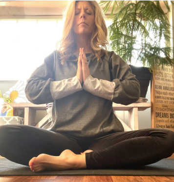 The author meditates on her yoga mat.