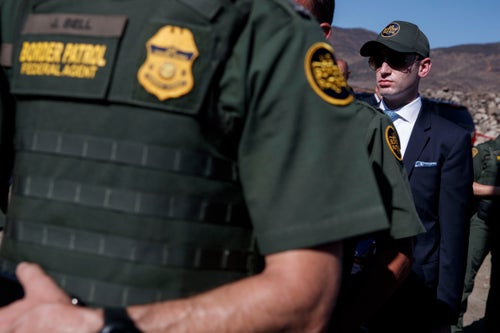 White House senior adviser Stephen Miller watches as President Donald Trump tours a section of the southern border wall, Wednesday, Sept. 18, 2019, in Otay Mesa, Calif. 