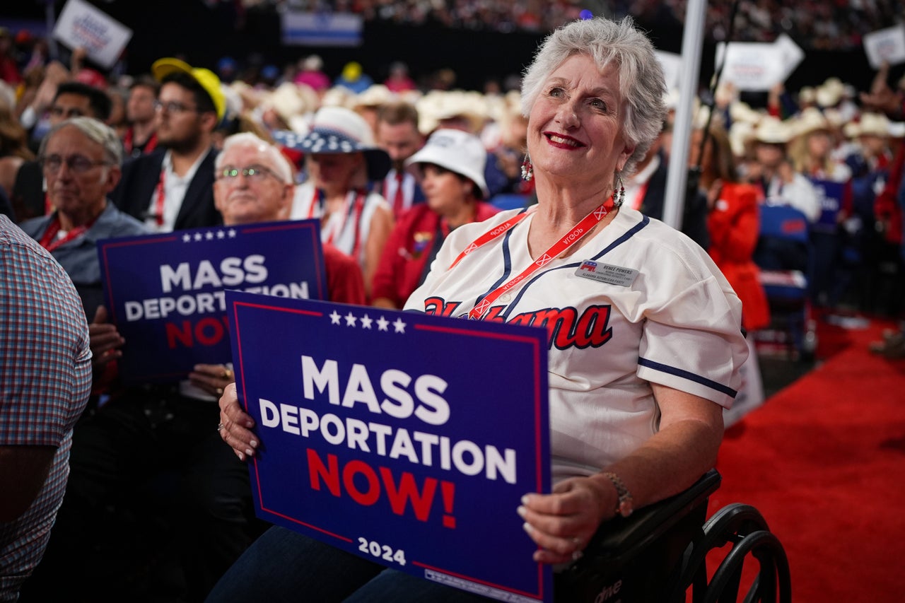 A person in a wheelchair holds a sign that reads "Mass Deportation Now" on the third day of the Republican National Convention at the Fiserv Forum on July 17, 2024 in Milwaukee, Wisconsin. 