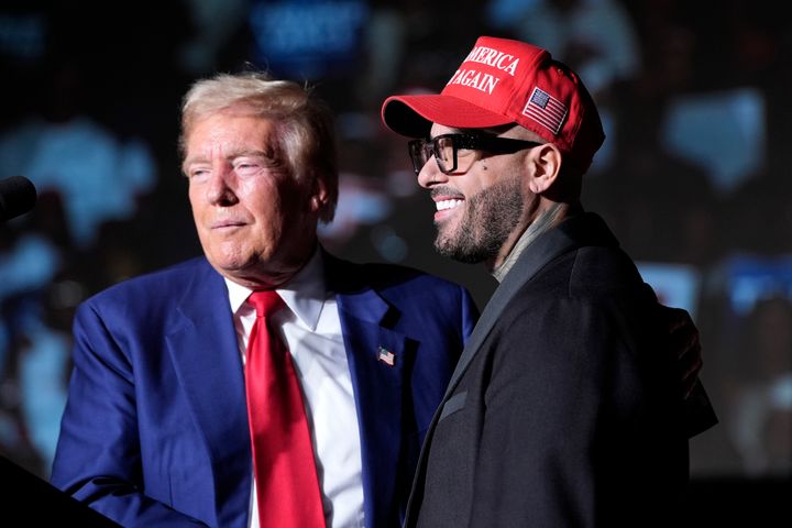 Republican presidential nominee former President Donald Trump, left, greets Nicky Jam during a campaign event at the World Market Center, Friday, Sept. 13, 2024, in Las Vegas. 