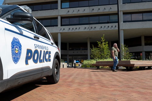 A man walks past the Springfield City Hall after bomb threats were made against buildings earlier in the day in Springfield, Ohio.