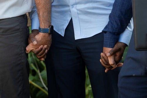 The executive director of the Haitian Community Help and Support Center, holds hands with pastors on Sept. 12 during a prayer at the end of a press conference where religious leaders called for calm and support after growing tensions about the Haitian population in Springfield exploded when former President Donald Trump spread debunked rumors that Haitians were stealing pets and eating them.