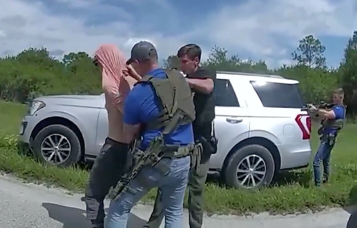 A screenshot taken from a video shows police officers arresting Ryan Wesley Routh, the suspect in an apparent assassination attempt.