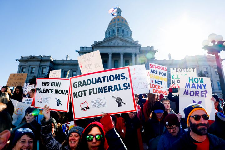 People march around the Colorado State Capitol during a protest to end gun violence in schools on March 24, 2023, in Denver, Colorado, following shootings linked to a local high school.