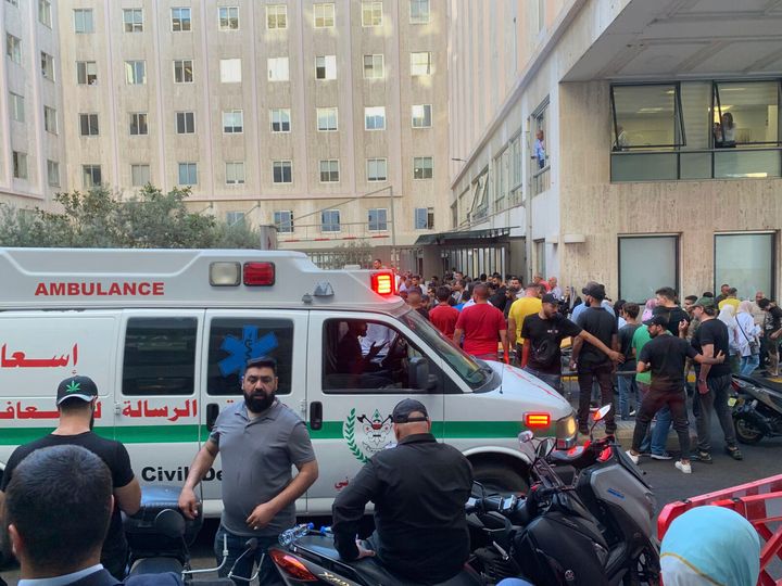 People gather outside the American University hospital after the arrival of several men who were wounded by exploded handheld pagers, in Beirut, Lebanon, Tuesday, Sept. 17, 2024. 