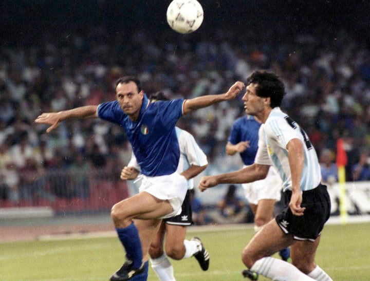 Italy's Salvatore "Totò" Schillaci, left, and Argentina's Juan Simon, right, chase the ball during the 1990 World Cup semi-final in Naples, Italy.