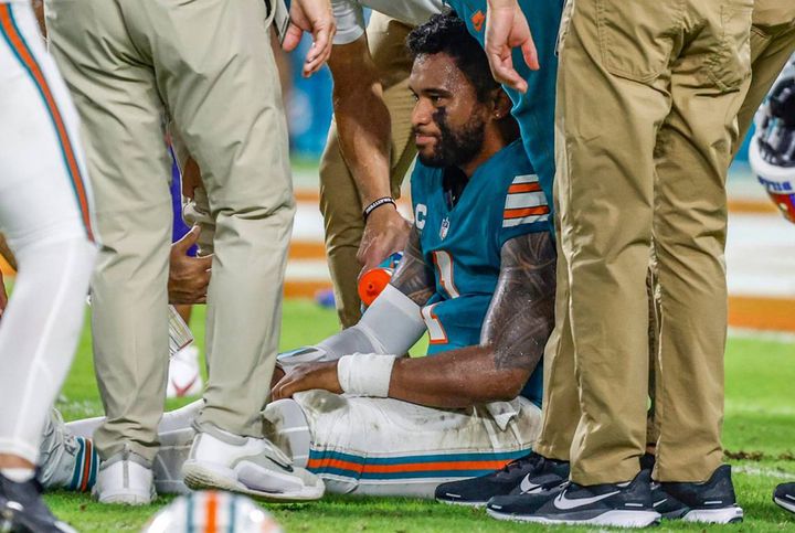 Miami Dolphins quarterback Tua Tagovailoa (1) sits on the field as he is attended to after an injury during the game against the Buffalo Bills in the second half at Hard Rock Stadium on Thursday, Sept. 12, 2024, in Miami Gardens, Florida.