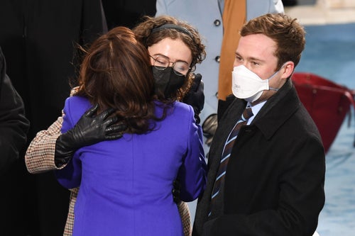 Vice President Kamala Harris photographed embracing stepchildren Cole and Ella Emhoff at the inauguration of President Joe Biden on January 20, 2021 at the US Capitol in Washington, DC.