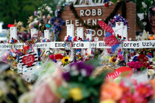 Crosses are surrounded by flowers and other items at a memorial on June 9, 2022, for the victims of a shooting at Robb Elementary School in Uvalde, Texas. 