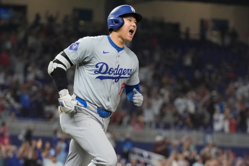Los Angeles Dodgers' Shohei Ohtani (17) reacts after hitting his 50th home run of the season during the seventh inning of a baseball game against the Miami Marlins, Thursday, Sept. 19, 2024, in Miami.