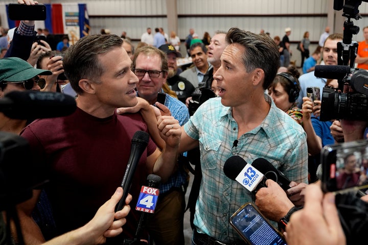 Incumbent Republican U.S. Senator Josh Hawley, right, and his Democratic opponent Lucas Kunce talk during the Governor's Ham Breakfast at the Missouri State Fair on Aug. 15, 2024. 