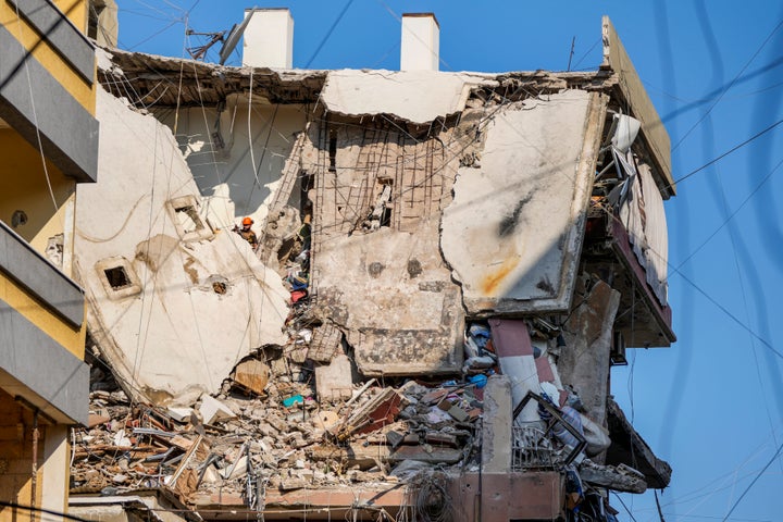 A rescuer searches for survivors in a building that was hit by an Israeli airstrike in Beirut's southern suburb.