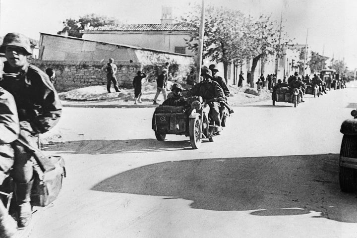 German army units entering Corinth, Greece, on April 27, 1941, after it had been captured. German paratroopers made a surprise attack on Corinth, capturing over 900 British soldiers and a large amount of light and heavy anti aircraft guns. (AP Photo)