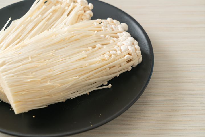 fresh enoki mushroom or golden needle mushrooms on plate