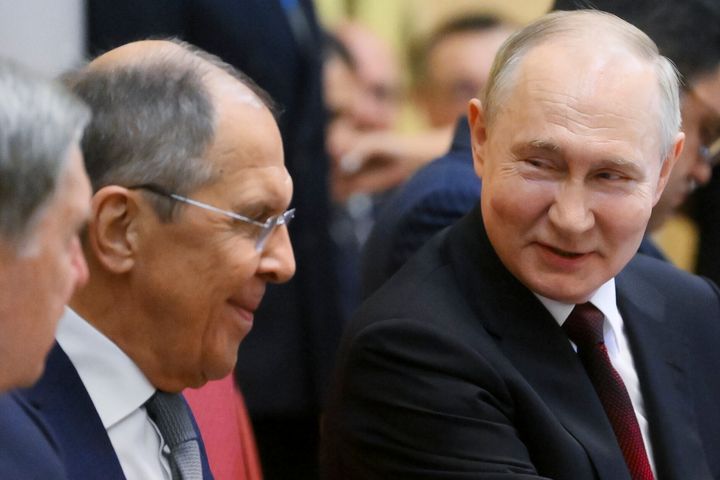 Russian President Vladimir Putin, right, speaks to Russian Foreign Minister Sergei Lavrov 