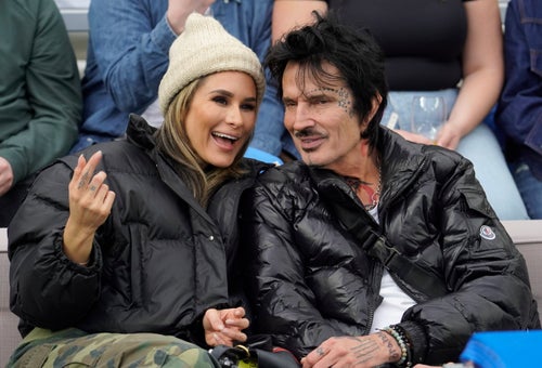 Brittany Furlan and Tommy Lee, pictured at a football game in January 2023, got their dog back when Furlan said she pulled it out of a coyote's mouth.