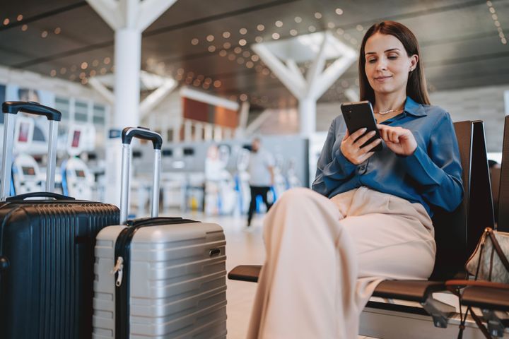 A woman at the airport using smartphone