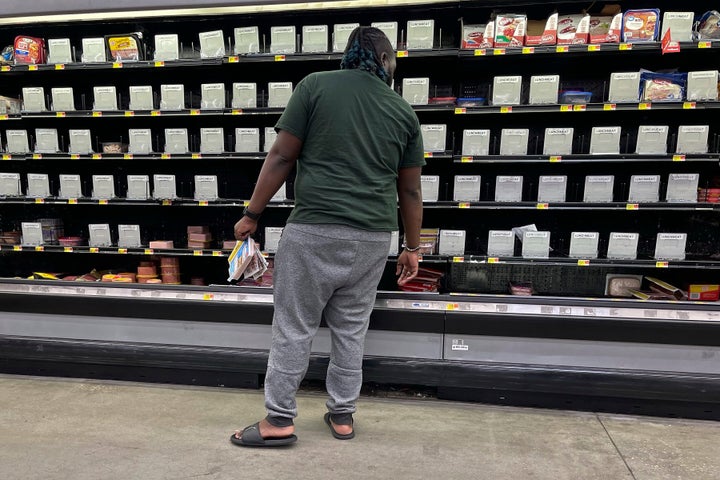 A shopper checks out nearly empty shelves in the lunch meat section of a Walmart, on Sept. 25, 2024 in Tallahassee, Fla. Grocery stores and gas stations were seeing heavy traffic in advance of Hurricane Helene, expected to make landfall Thursday night in the Big Bend area. 