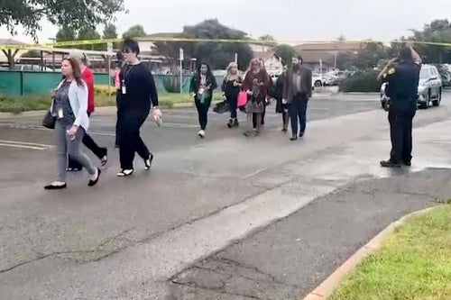 In this still image from video provided by KEYT, people walk past a police barricade following an explosion at the Santa Maria Courthouse in Santa Maria, Calif., Wednesday, Sept. 25, 2024.