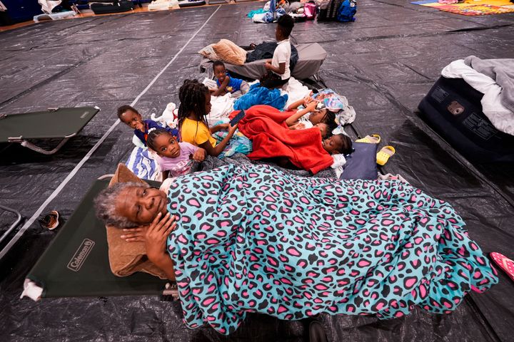 Vera Kelly, of Tallahassee, lies on a cot after evacuating to a hurricane shelter with her grandchildren and great grandchildren, at Fairview Middle School, ahead of Hurricane Helene on Thursday, Sept. 26, 2024, in Leon County, Fla. (AP Photo/Gerald Herbert)