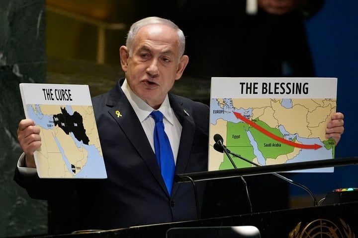 Prime Minister of Israel Benjamin Netanyahu hold signs as he addresses the 79th session of the United Nations General Assembly, Friday, Sept. 27, 2024. (AP Photo/Pamela Smith)