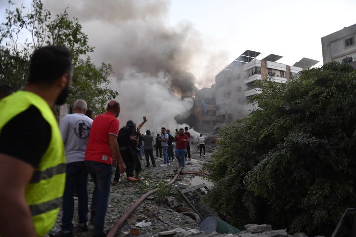 Lebanese civil defense and firefighting teams arrive in the damaged area following the Israeli attacks as around 10 explosions are heard in the southern area of the capital Beirut, Lebanon on September 27, 2024. (Photo by Houssam Shbaro/Anadolu via Getty Images)