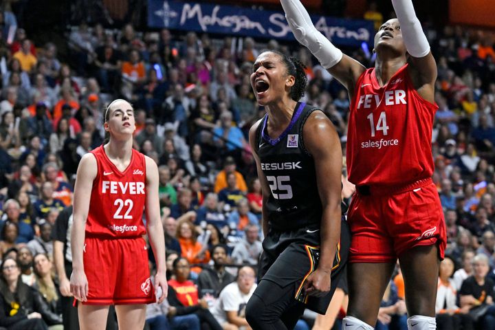 Connecticut Sun forward Alyssa Thomas, center, is seen with Indiana Fever players Caitlin Clark at left and Temi Fagbenle at right during a WNBA playoff series game, Wednesday, Sept. 25, 2024, in Uncasville, Connecticut.