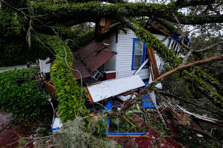 A damaged 100-year-old home is seen after an Oak tree landed on it after Hurricane Helene moved through the area, Friday, Sept. 27, 2024, in Valdosta, Ga. (AP Photo/Mike Stewart)