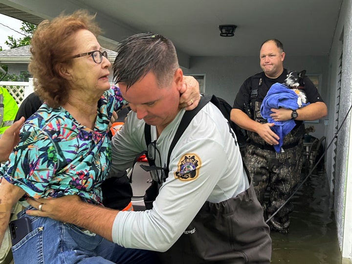 This photo provided by Venice Police Department rescue crews assist residents after conducting door-to-door wellness checks, in coastal areas that were flooded by Hurricane Helene on Friday, Sept. 27, 2024 in Venice, Fla . (Venice Police Department via AP)